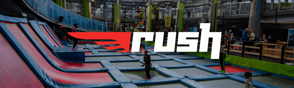 Trampoline zone at Rush Greenstone featuring colorful trampolines with kids jumping and playing in a safe, energetic environment.