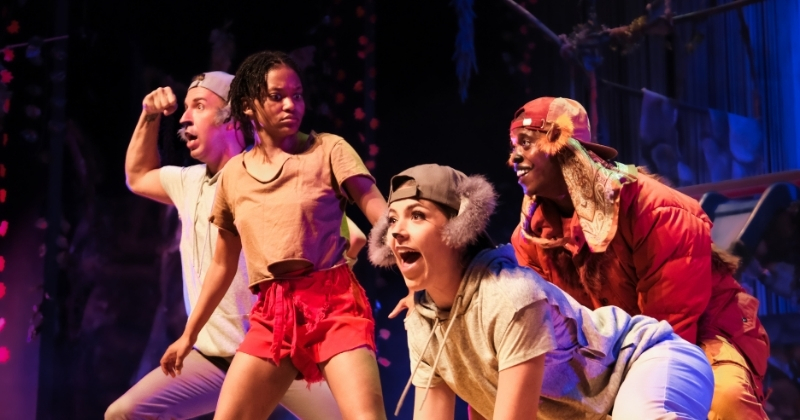 The Jungle Book actors in character, showcasing the lively and energetic stage performance.