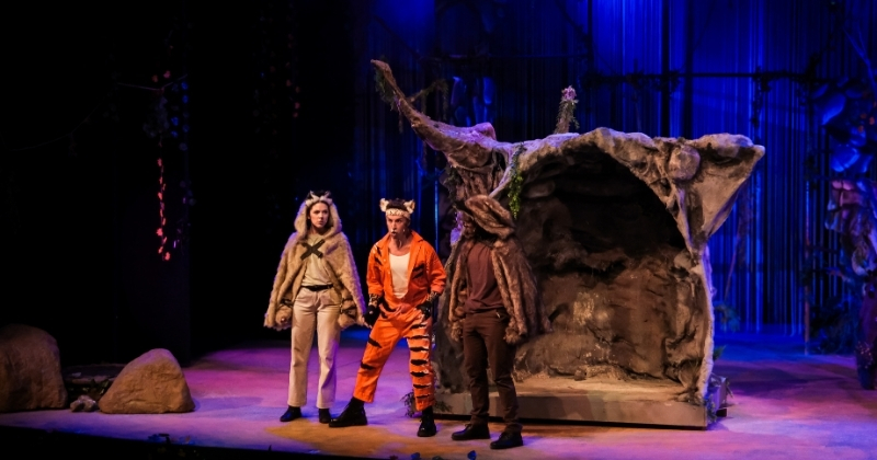 Actors dressed as jungle animals in The Jungle Book, performing on a colorful stage