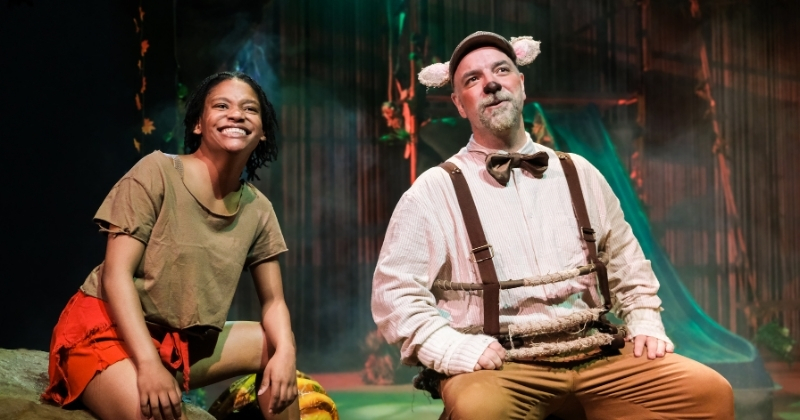 Two actors from The Jungle Book stage show, smiling and performing together.