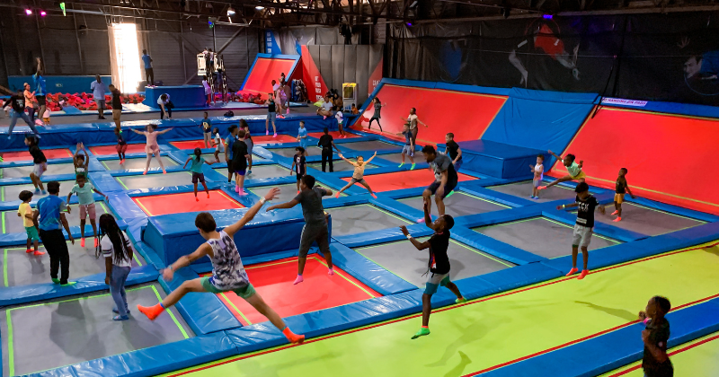 Teens and kids having fun jumping on trampolines at Rush Claremont in Cape Town.