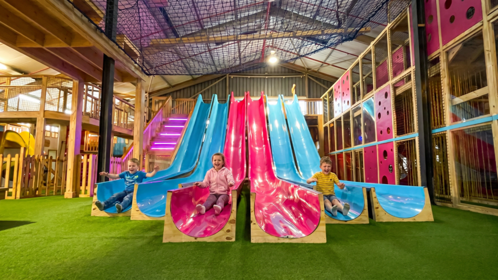 Children playing on colourful indoor slides at PlayStation by Rush, a fun winter activity for kids in Cape Town.