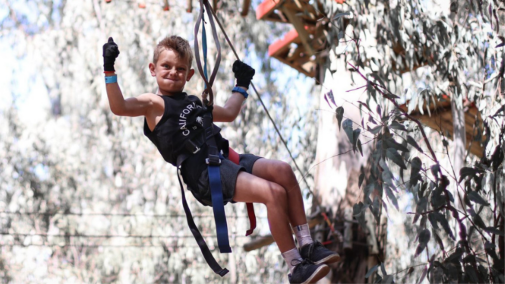 Young child ziplining through a treetop adventure course, enjoying an outdoor family activity for the Gauteng Winter Guide.