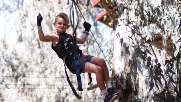 Young child ziplining through a treetop adventure course, enjoying an outdoor family activity for the Gauteng Winter Guide.