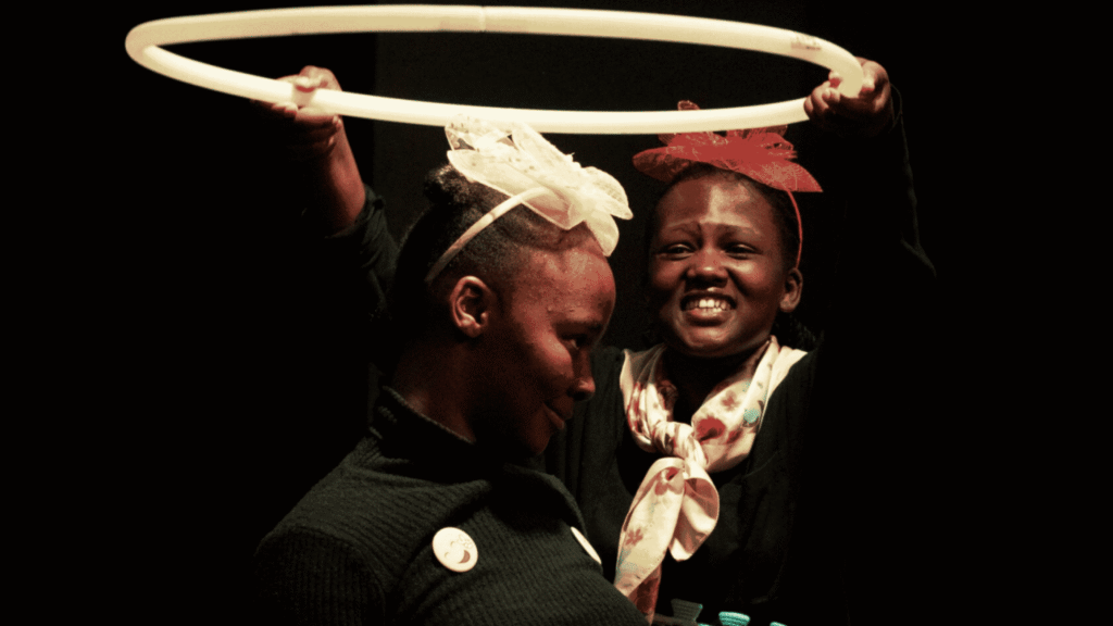 Performers in Dimpho and the Cat Fish pose with a large hoop during the Cradle of Creativity Festival 2026.