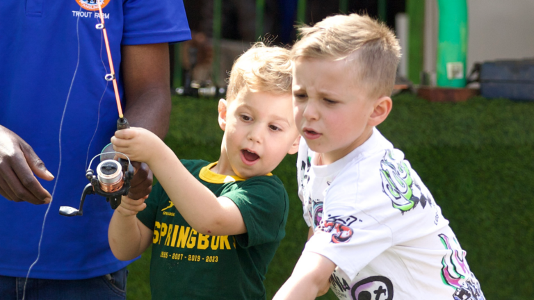 Young boys learning to fish at the kids’ fishing dam at XFactor Trout Farm