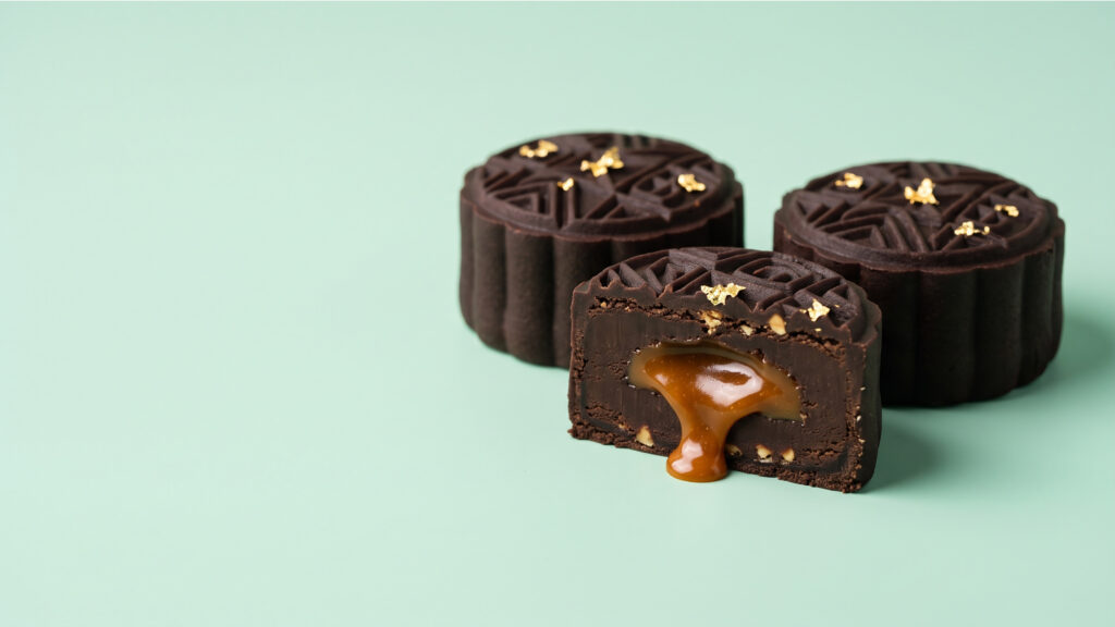 Chocolate mooncakes decorated with edible gold details for a kids’ baking workshop